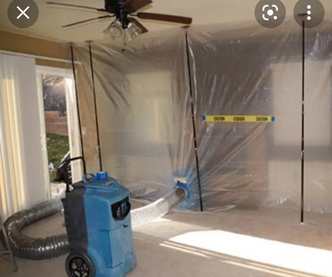 Plastic containment and a negative air machine set up inside a house